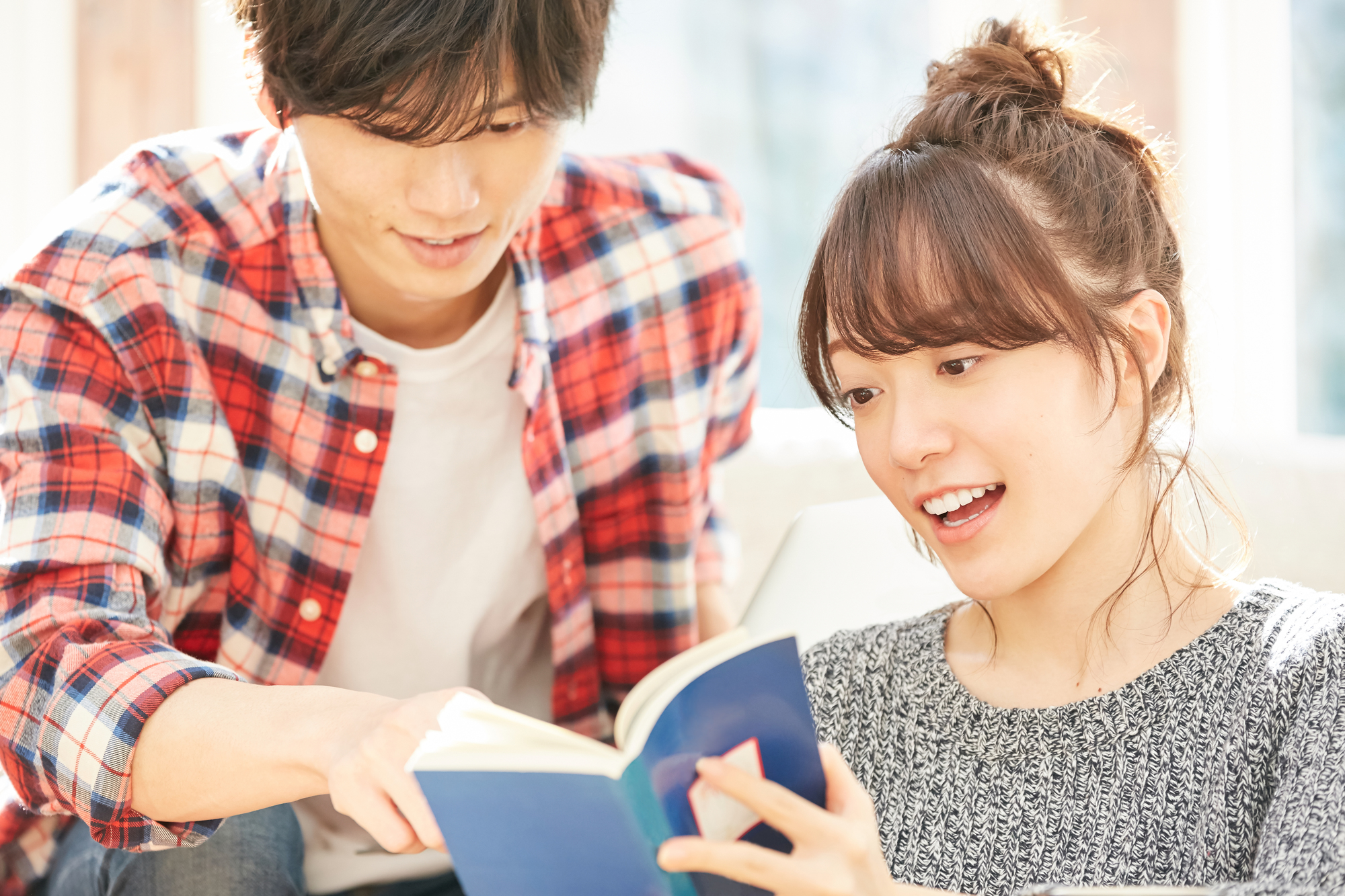 本を見ながら会話を楽しむ男女